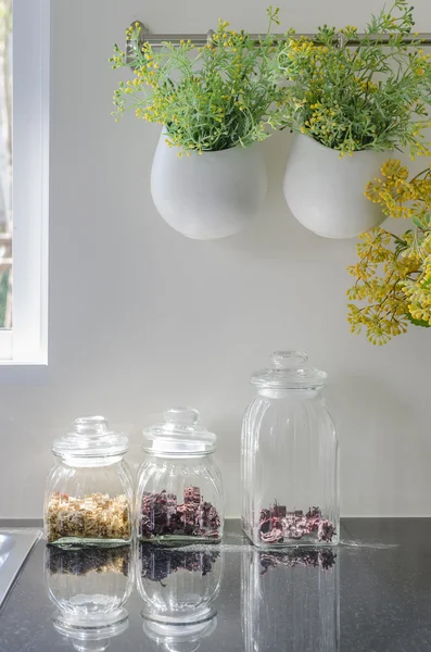 Bowl of plants hang on bar rail with glass vase — Stock Photo, Image