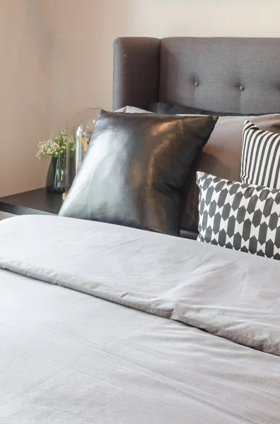 Black and white pillows on modern bed — Stock Photo, Image