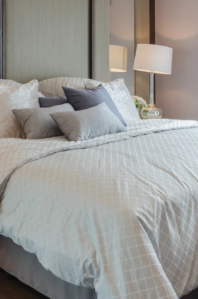 Luxury bedroom with grey pillows on bed — Stock Photo, Image