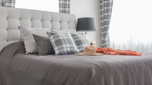 Classic bed with pillows, hat, cloth and black lamp — Stock Photo, Image