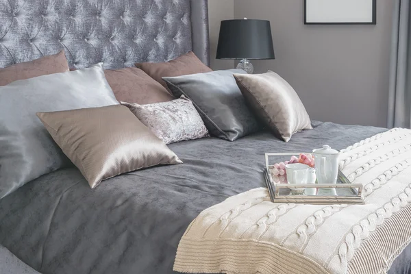 Luxury bed with pillows and tray of tea set on blanket — Stock Photo, Image