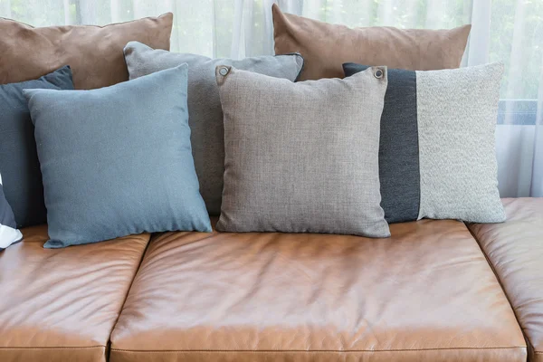 Pillows on brown leather sofa — Stock Photo, Image