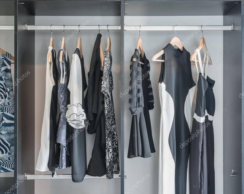 Black And White Clothes Hanging In Closet Stock Photo
