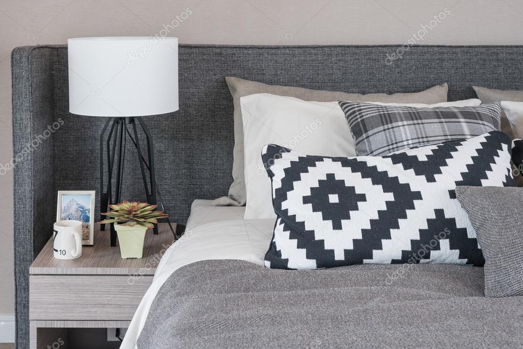 Black and white pillows on modern bed — Stock Photo