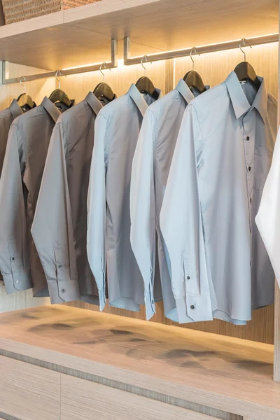 Row of shirts hanging on rail — Stock Photo, Image