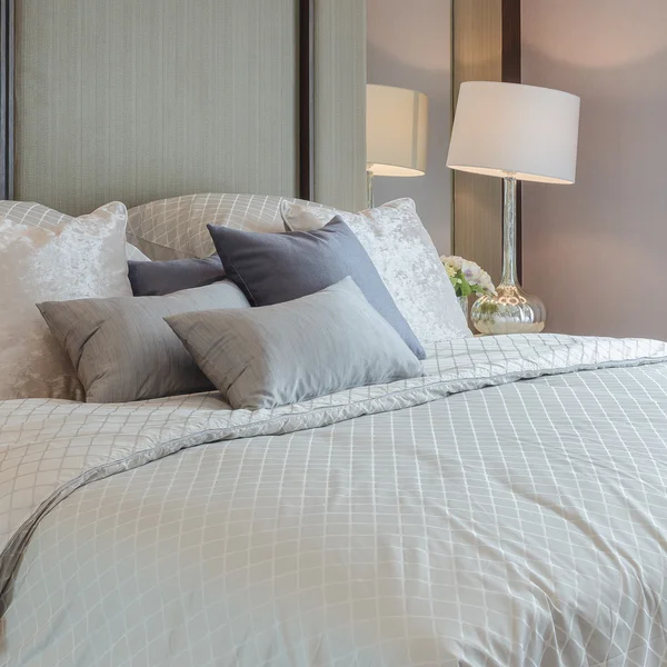 Luxury bedroom with grey pillows on bed — Stock Photo, Image