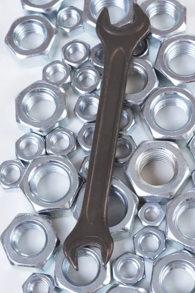 Metal nuts and wrench — Stock Photo, Image