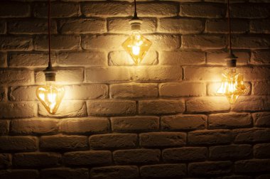 Duvarda asılı duran kabloların ışıkları. Karanlık bir odadaki ışıklar.