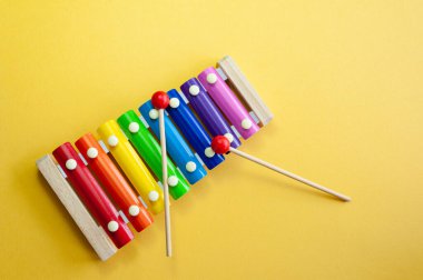 Sarı zemin üzerinde izole edilmiş çok renkli ksilofon müzik enstrümanı