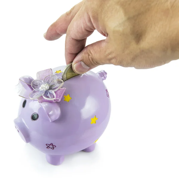 Saving, male hand putting a money into piggy bank isolated on white background. — Stock Photo, Image