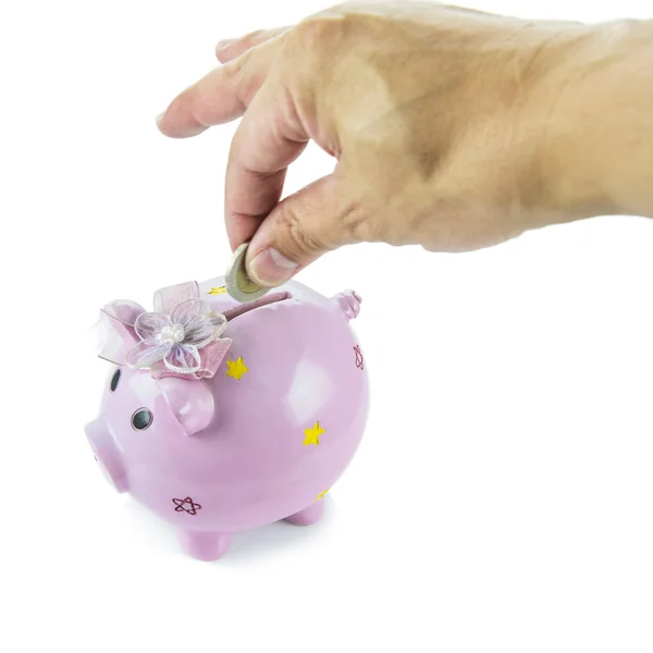 Saving, male hand putting a money into piggy bank isolated on white background. — Stock Photo, Image