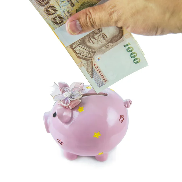 Saving, male hand putting a money into piggy bank isolated on white background. — Stock Photo, Image