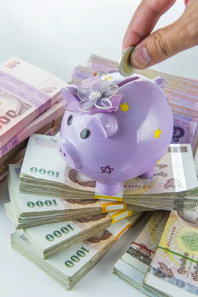 Saving, male hand putting a money into piggy bank isolated on white background. — Stock Photo, Image