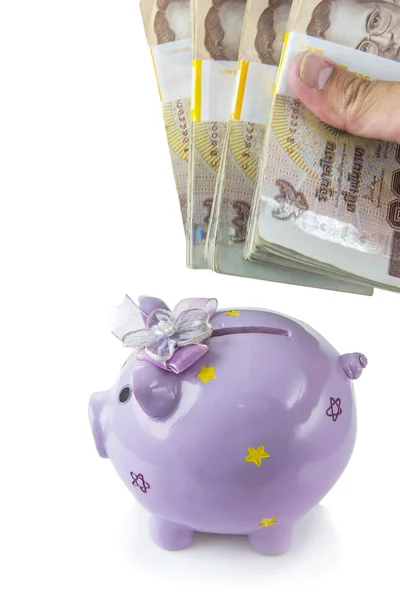 Saving, male hand putting a money into piggy bank isolated on white background. — Stock Photo, Image