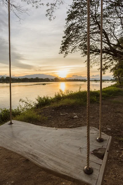 Lone swing at river side and sunset ,Thailand . — Stock Photo, Image