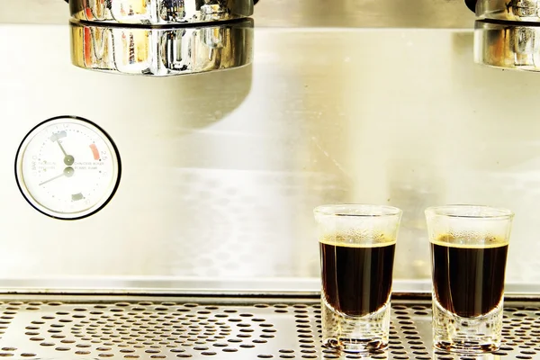 Two espresso shots on coffee machine background — Stock Photo, Image