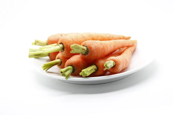 Fresh baby carots on white plate — Stock Photo, Image