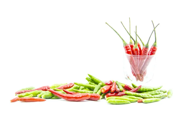 Green red cayenne peppers with shot glass — Stock Photo, Image