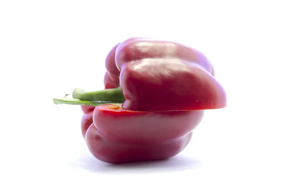Red bell chili half sliced with green stick from side — Stock Photo, Image