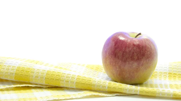 Fresh apple on yellow table mat — Stock Photo, Image