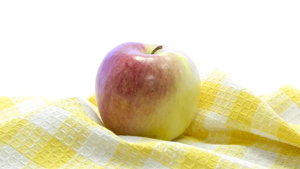 Fresh apple on yellow table mat — Stock Photo, Image