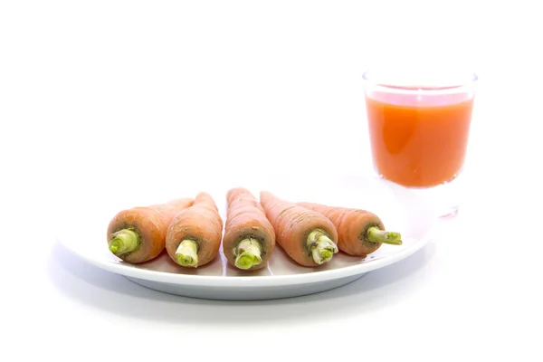 Glass of  juice with carrots on plate — Stock Photo, Image