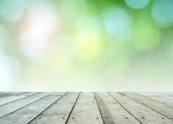 Leaf bokeh background with wooden paving. — Stock Photo, Image