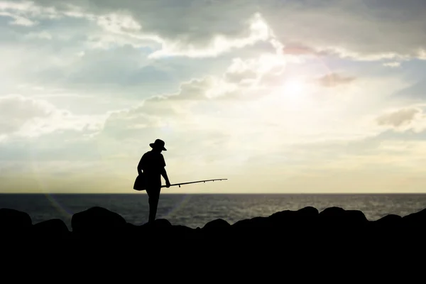 Silhouette of man fishing rod sunset background. — Stock Photo, Image