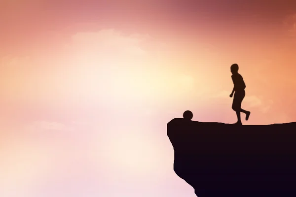 Silhouette of children playing football on a cliff. — Stock Photo, Image