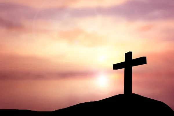 Silhouette the cross over blurred sunset background. — Stock Photo, Image