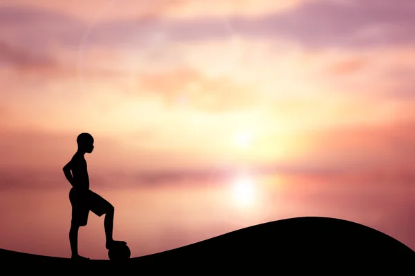 Silhouette of children playing soccer background sunset. — Stock Photo, Image