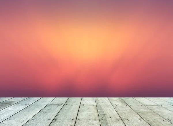 Blurred sunset with wooden paving. — Stock Photo, Image