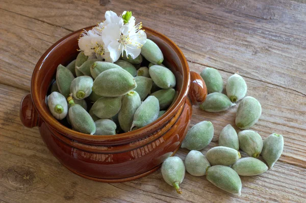 Green almonds on a wooden board. — Stock Photo, Image
