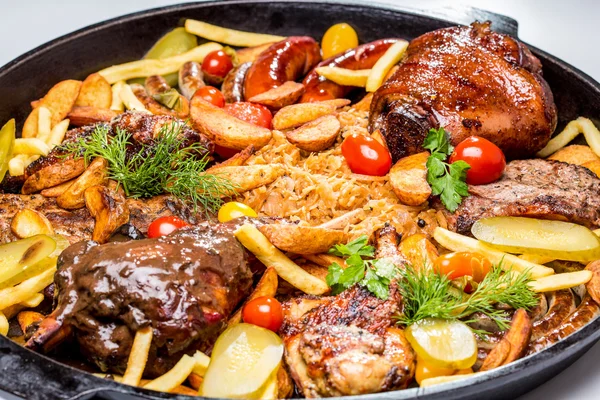 Carne variada con rodajas de patata y col estofada. En una sartén — Foto de Stock