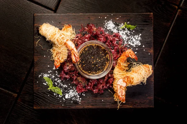 Tempura king langostinos con salsa de soja y hierbas en un tablero de madera oscura — Foto de Stock