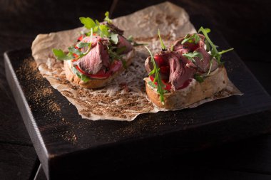 Biftek ve roka ile ahşap bir tahtanın üzerinde