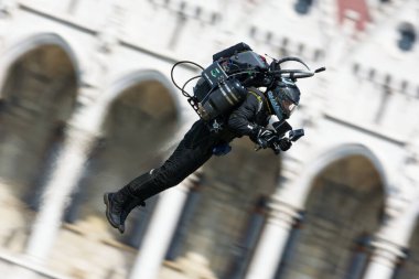 Budapest, Hungary - June 23, 2018: Jet Pack Man flying by Hungarian Parliament Building at Red Bull Air Race (The World Air Sports Federation event) clipart