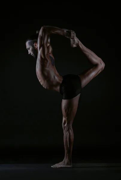 Man practicing yoga, studio photo Stock Photo