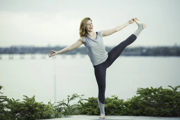 genç kadın bir arka plan nehir, gülümsüyor ve kahkaha yoga uygulamaları