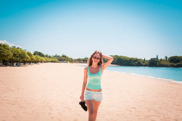 Vrouw die langs het strand loopt — Stockfoto