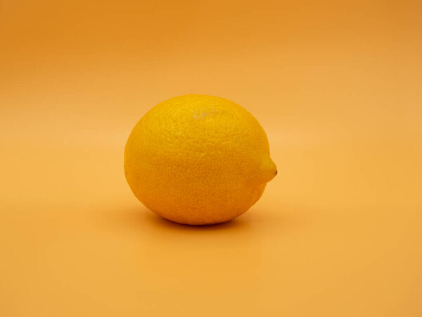 One yellow lemon on a gold fortune background