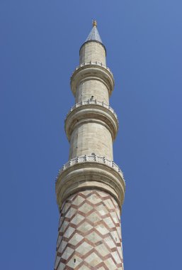 Mavi gökyüzü arkadaki bir caminin minaresi
