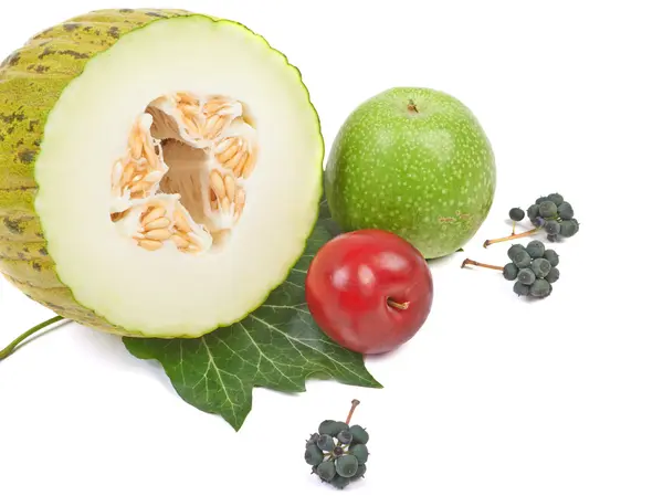 Sliced melon, green apple, plum and black berries isolated on a — Stock Photo, Image