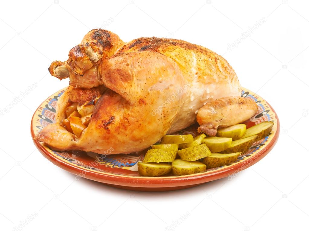 Fried chicken on a plate with pickles on a white background isol