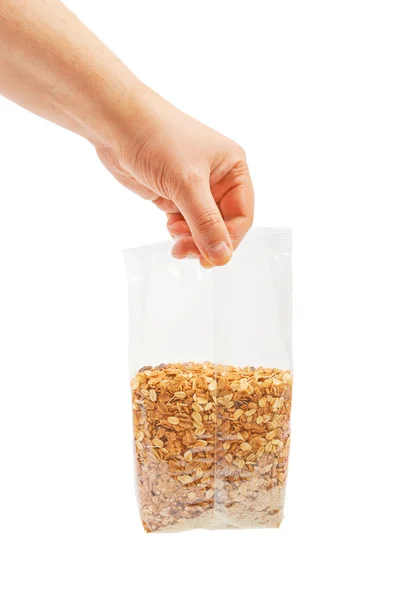 Oatmeal flakes into hand. Isolated on a white background. — Stock Photo, Image