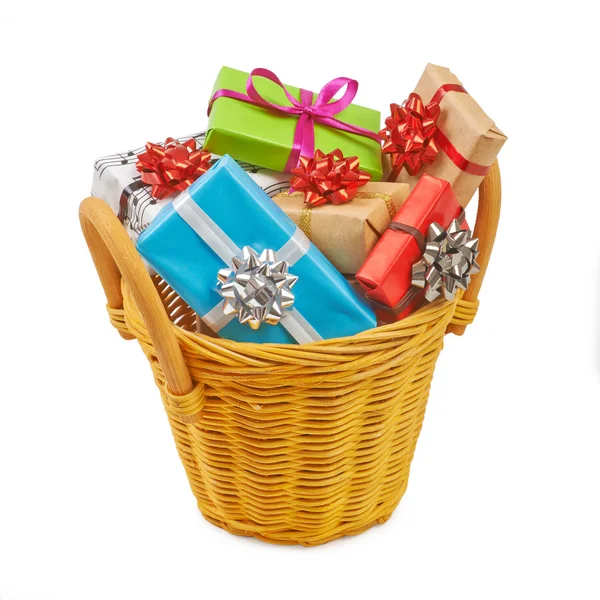 Many colored gift boxes in a basket isolated on white background — Stock Photo, Image