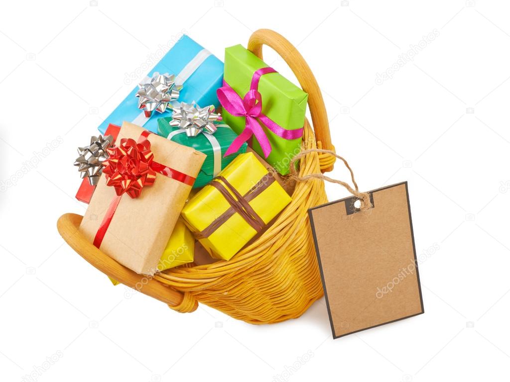 Many colored gift boxes in a basket isolated on white background