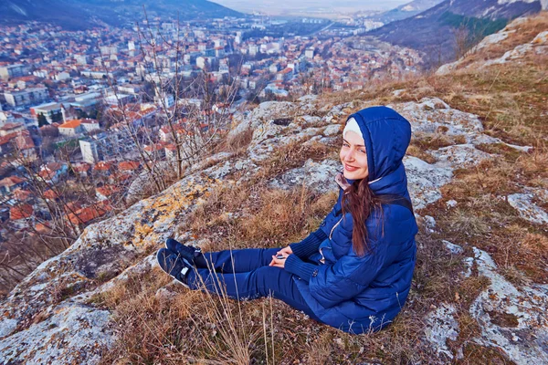 Young woman in a coat sitting — Stock Photo, Image