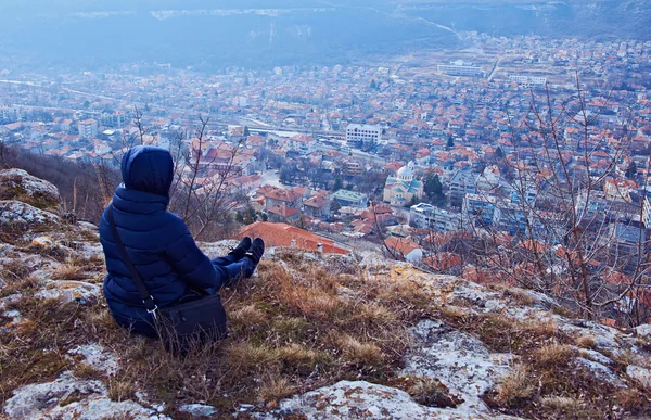 Young woman in a coat sitting — Stock Photo, Image