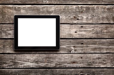 Eski ahşap masa üzerinde dijital tablet
